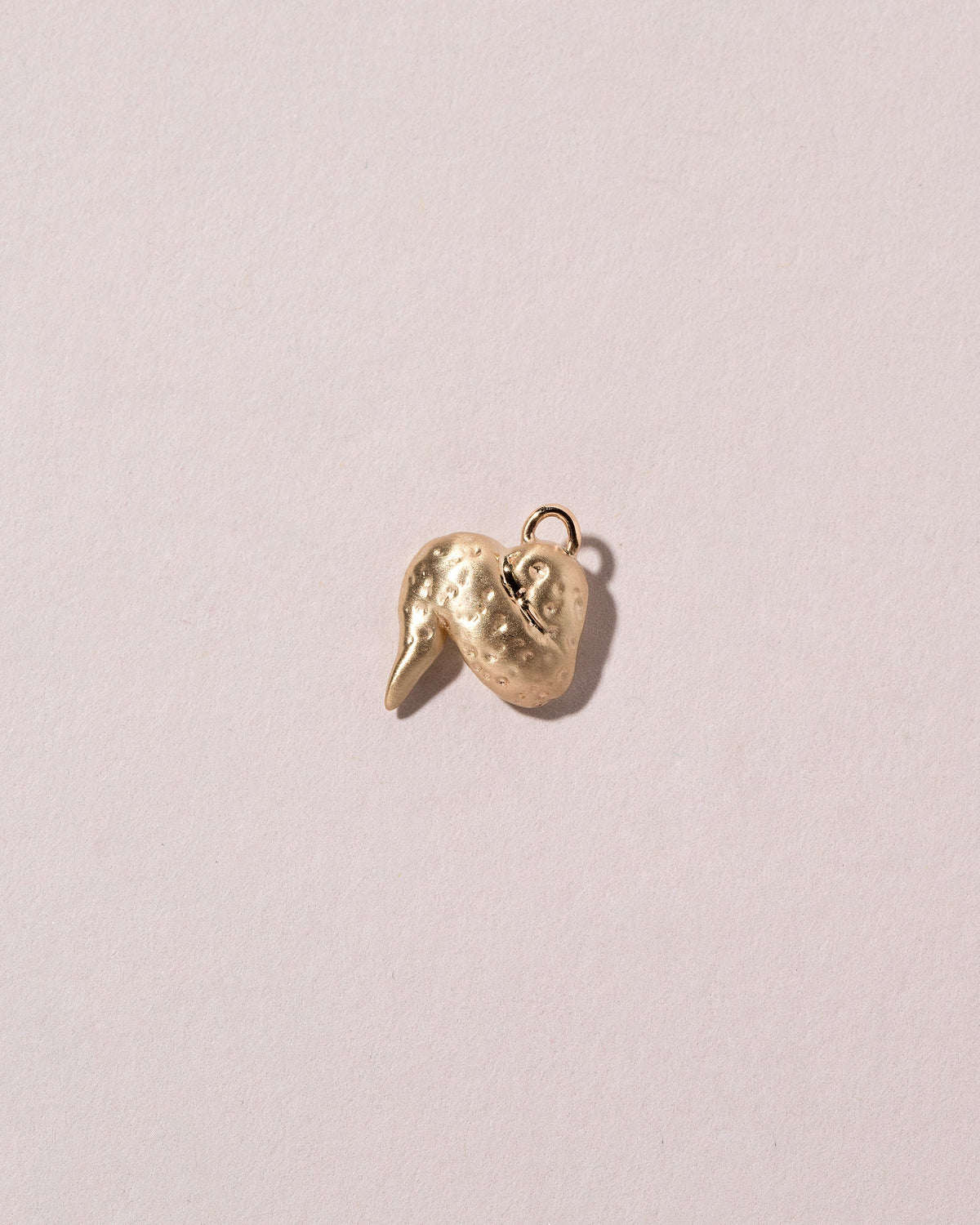  Chicken Wing Charm on light color background.
