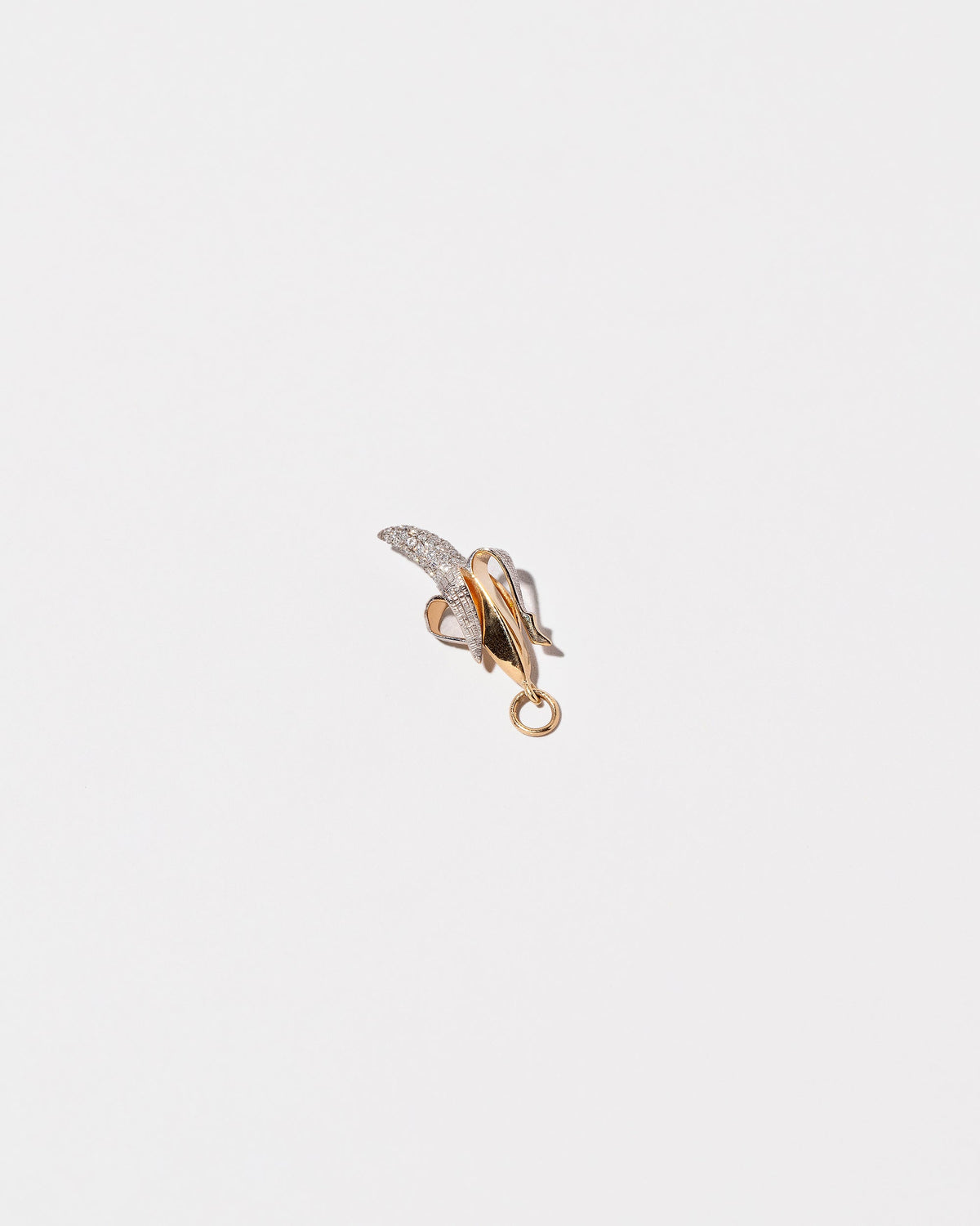 View from the side of the Peeled Banana Charm on light color background.