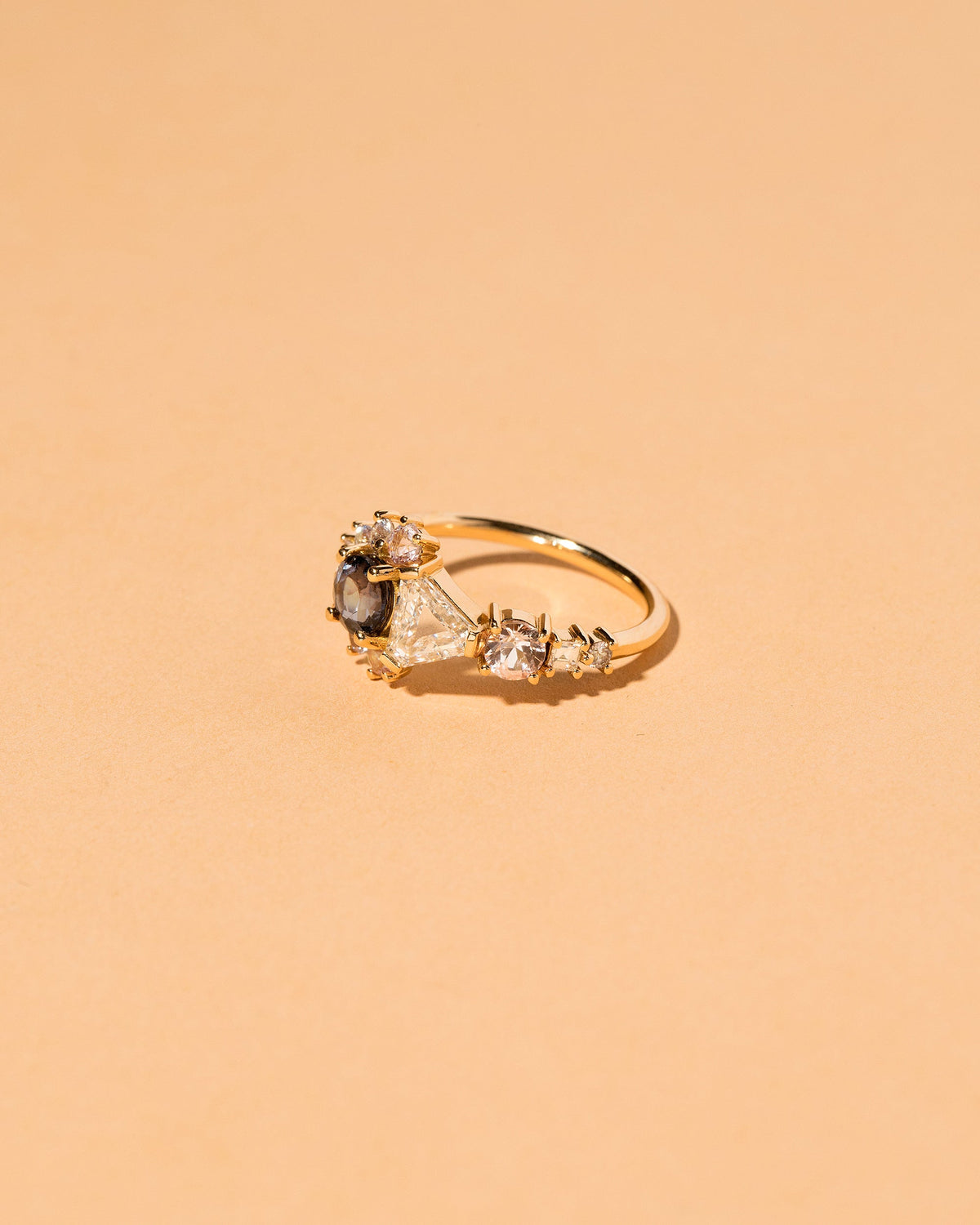  Diamond, Spinel & Sapphire Cluster Ring on light color background.