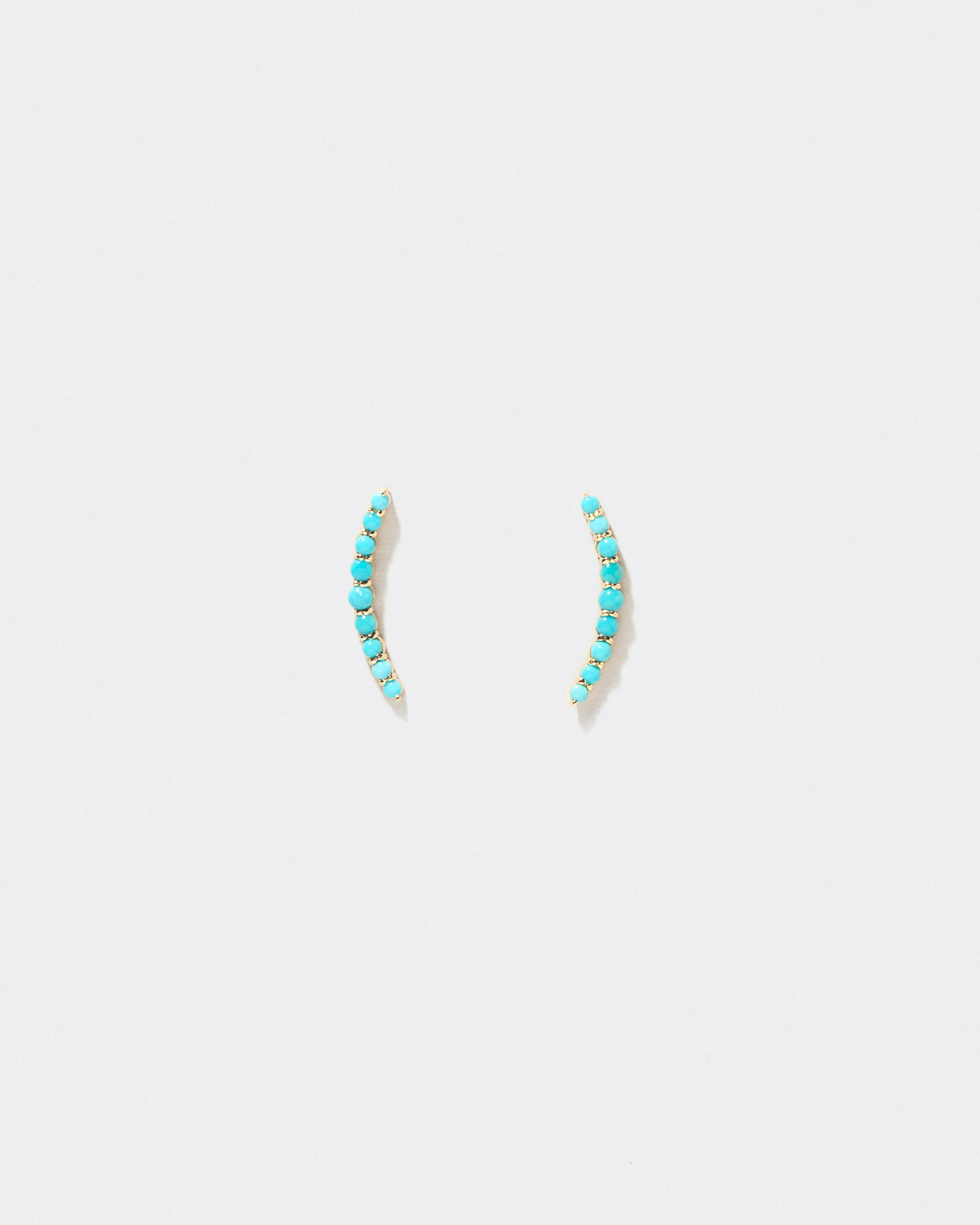 Crescent Ear Climber Stud Earrings - Turquoise on a light background.