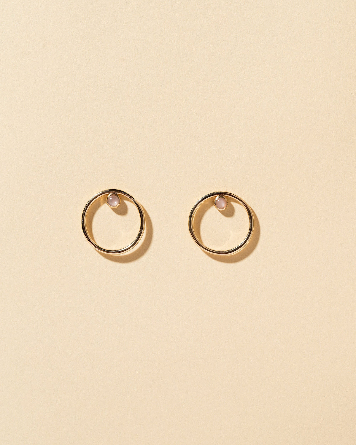  Coil Stud Earrings on light color background.