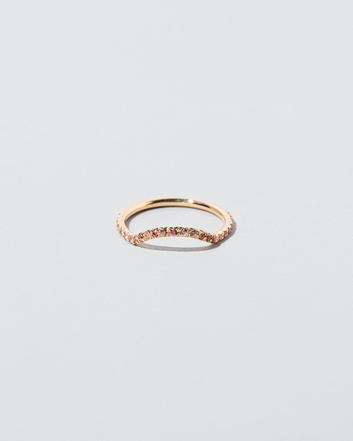 Mini Curve Band with pavé set peach sapphires on light color background.