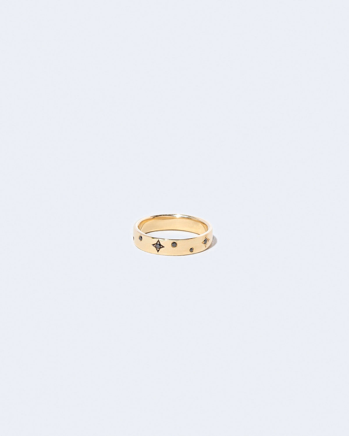 Gold 4mm Square Wire Band with Little Array Black Diamonds added on light color background.