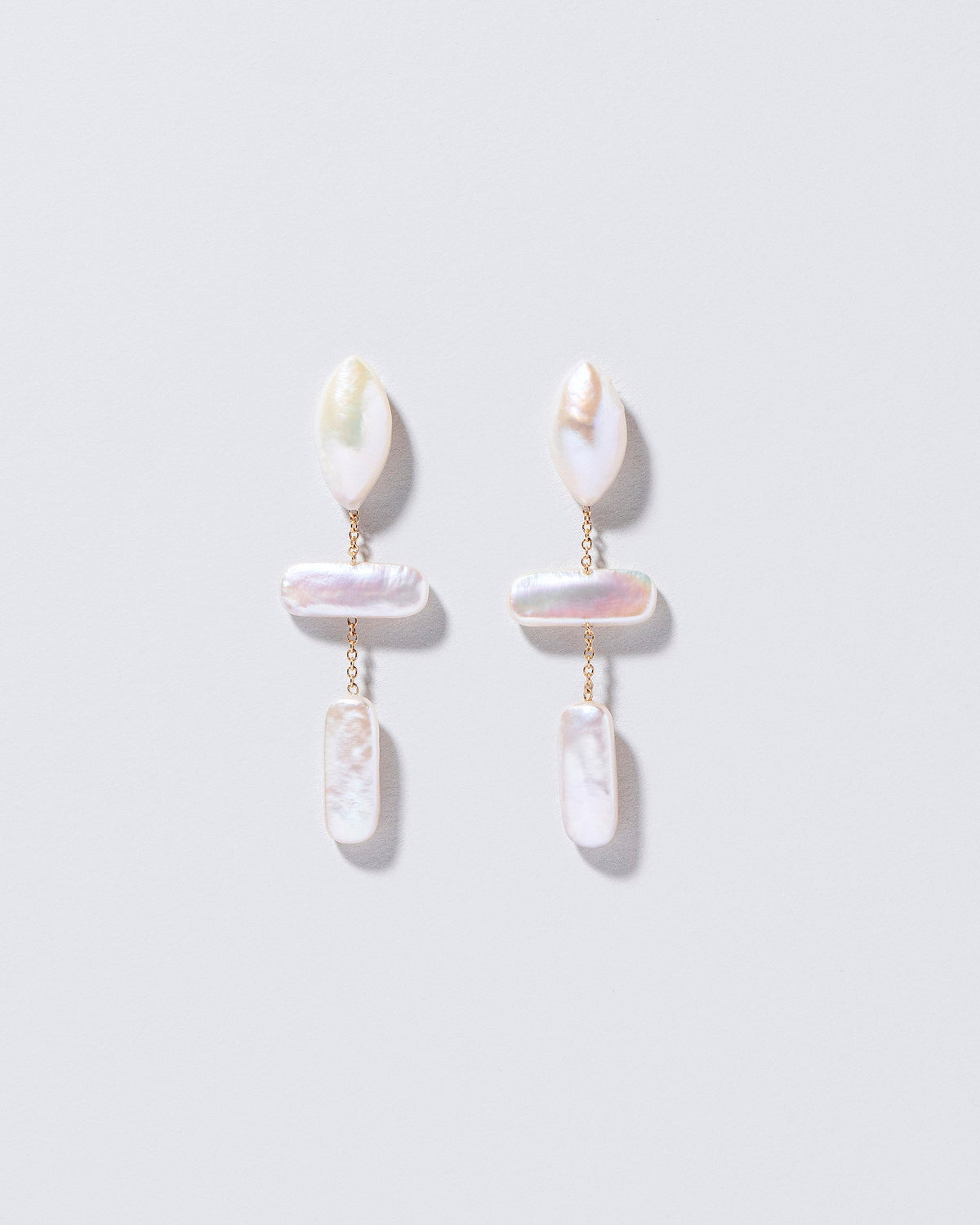  Nauplius Earrings on light color background.