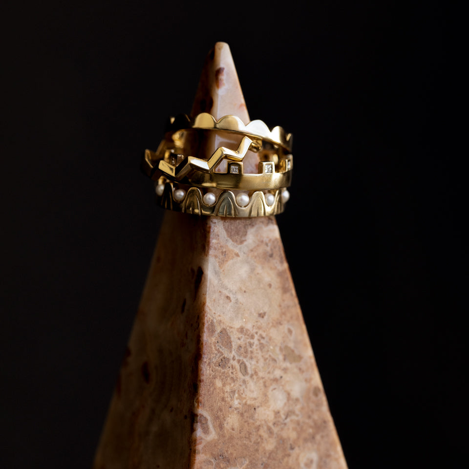 product_details::Styled image featuring the Gold Perfect Balance Band, Gold Eternal Moon Band, Gold White Diamond Connection Band and Gold Pearls of Wisdom Band.