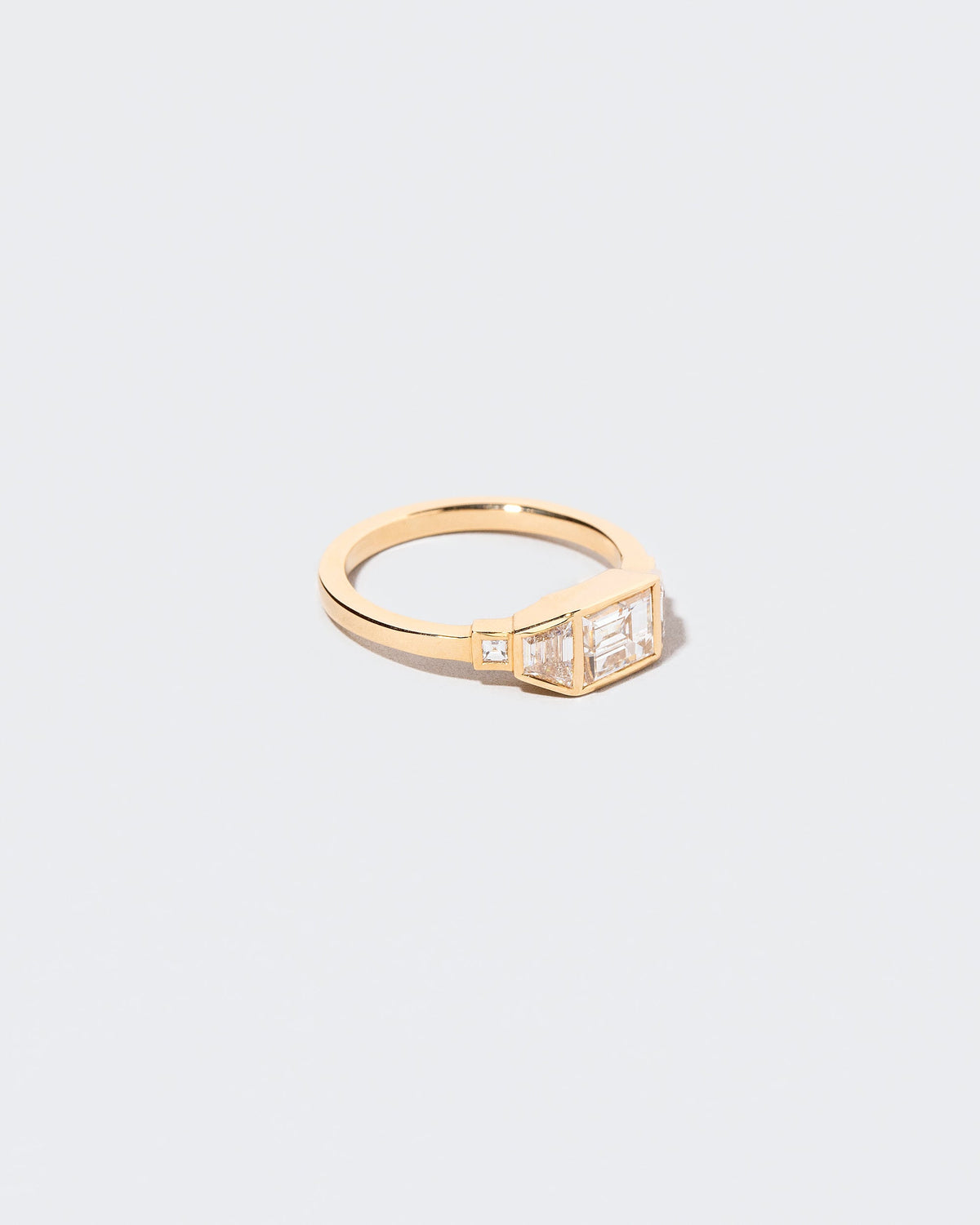 View from the side of the Venus Carré Ring on light color background.